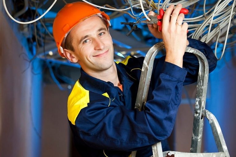 Construction repairman with a combination pliers on a stepladder