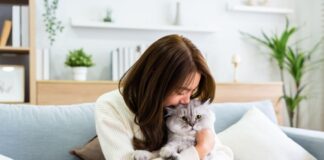 Domestic Violence young woman cuddling cat on couch