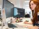 A woman in an office researching computer telephony integration on her computer